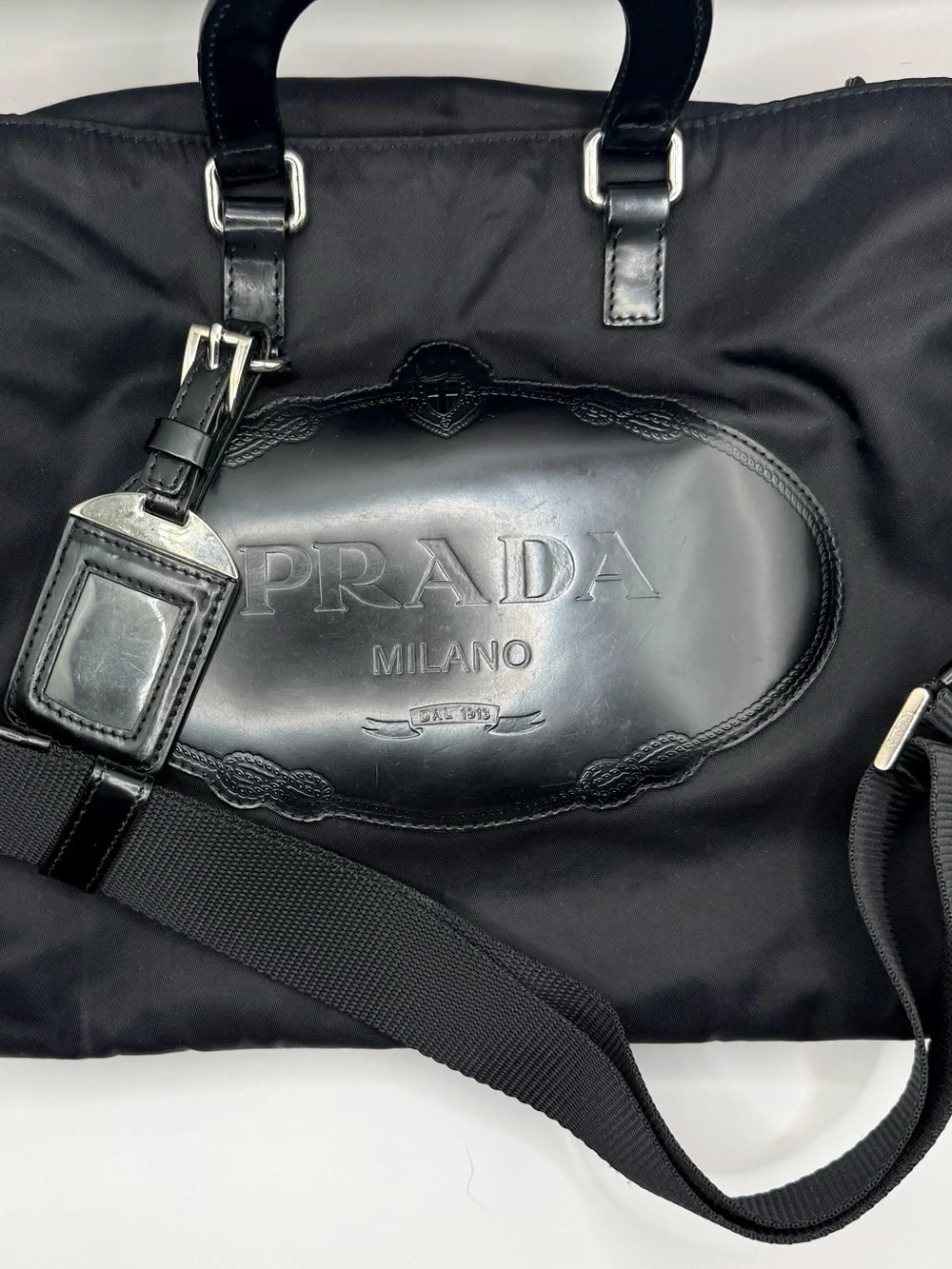 Prada Black Nylon & Leather Bag with Embossed Prada logo.